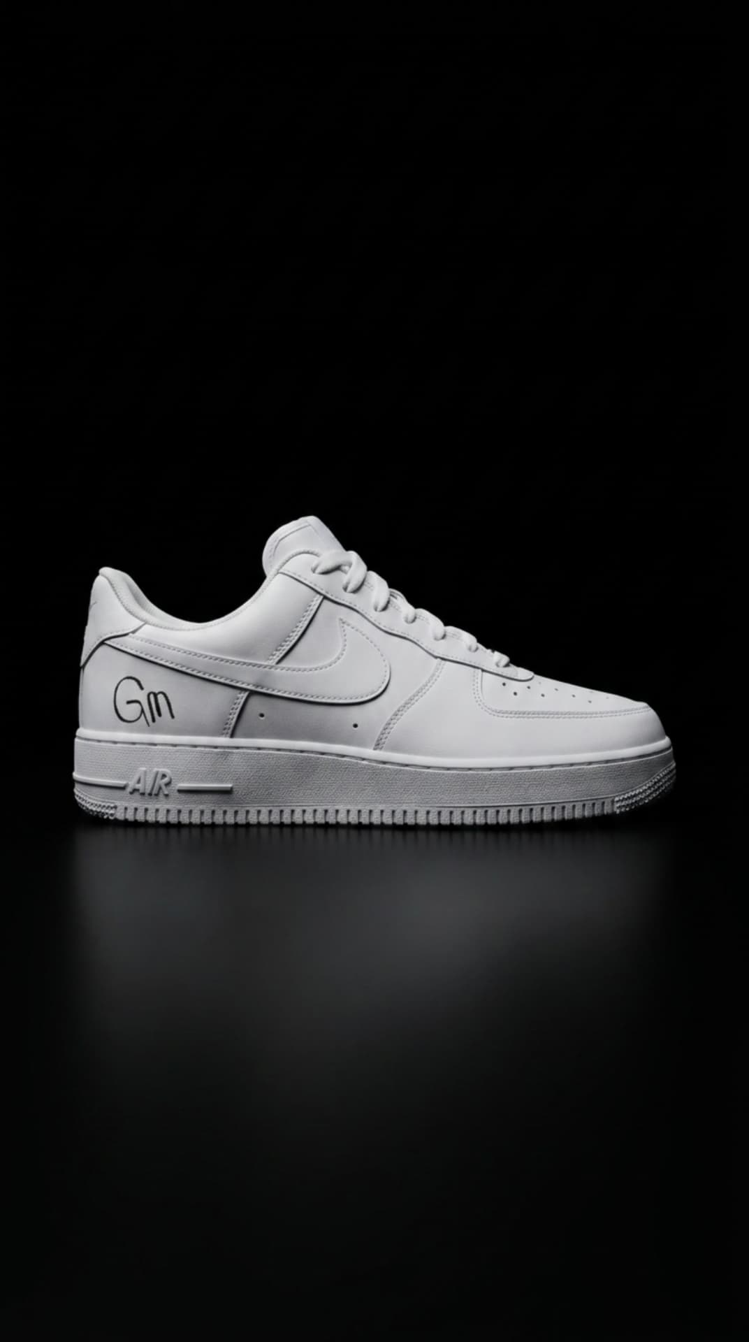 All-white Air Force 1 with a hand-drawn GM mark on the panel, floating against a black void