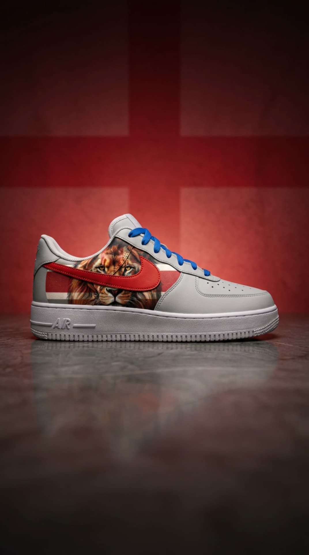 Grey Air Force 1 with a lion panel, red swoosh and blue laces against a deep red England flag backdrop