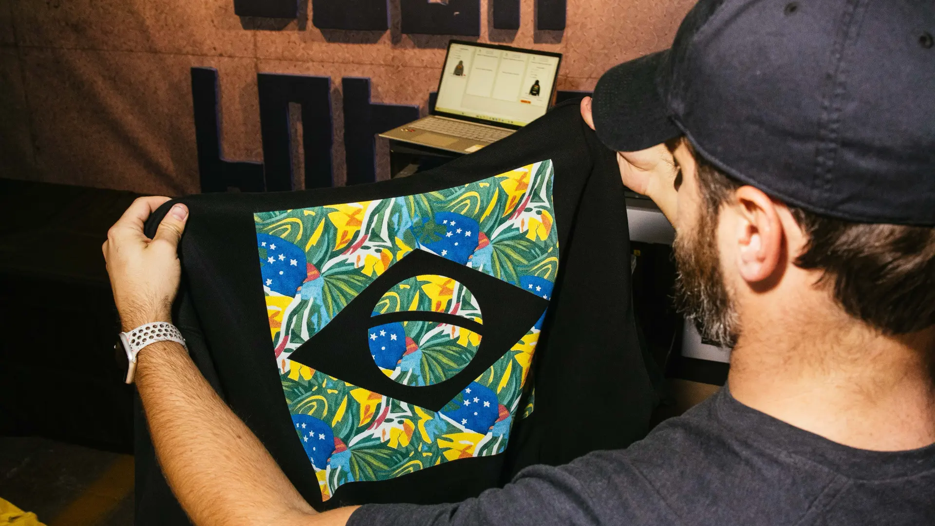 Freshly printed Brazil flag hoodie held up in the print room