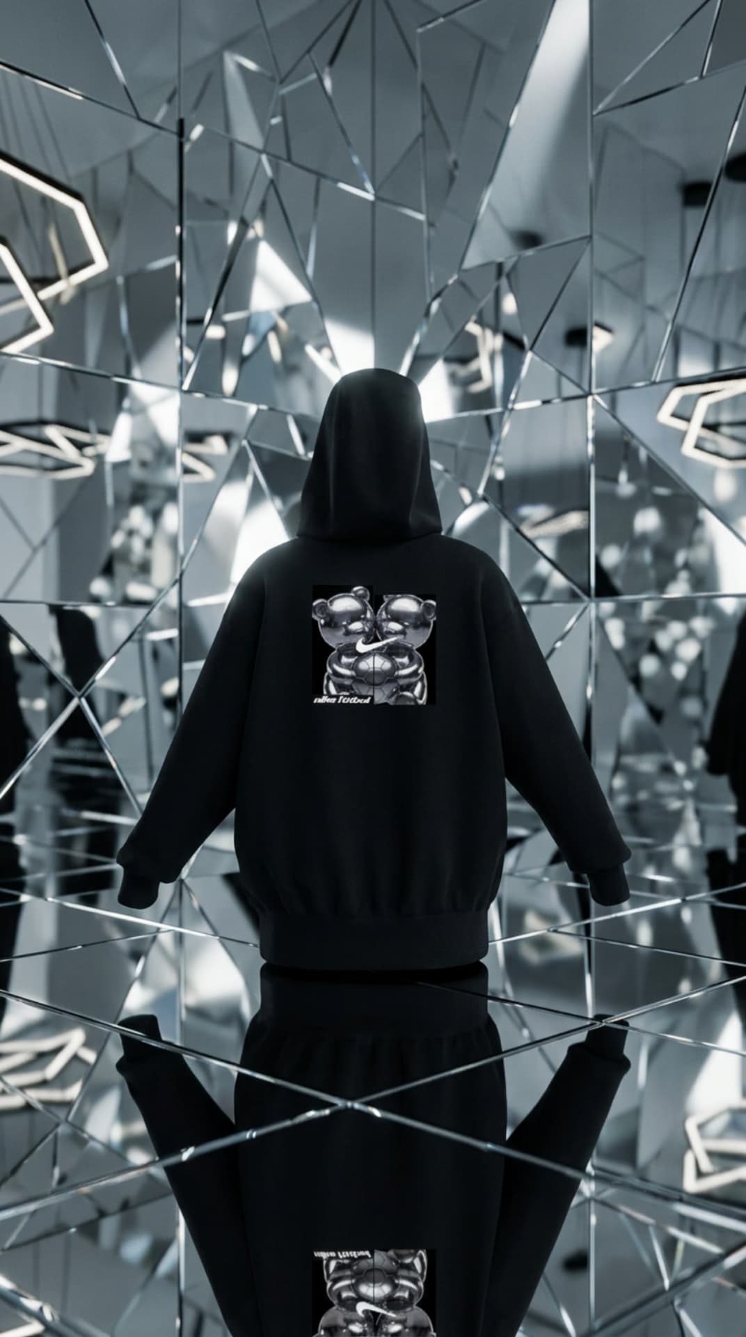 Black hoodie with a chrome mirror-print Swoosh box graphic in a mirrored room