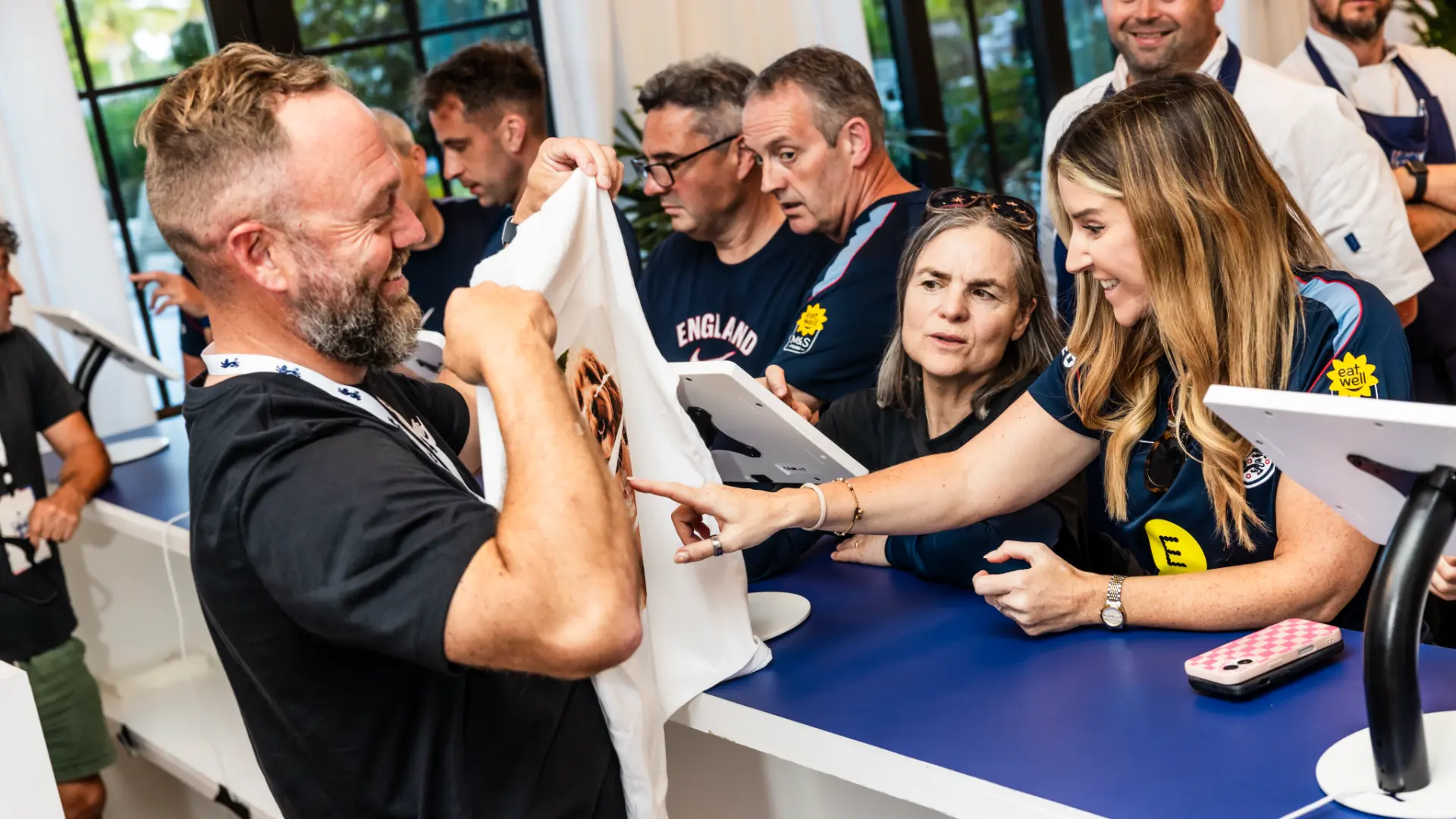 England guests reviewing a printed tee at the activation