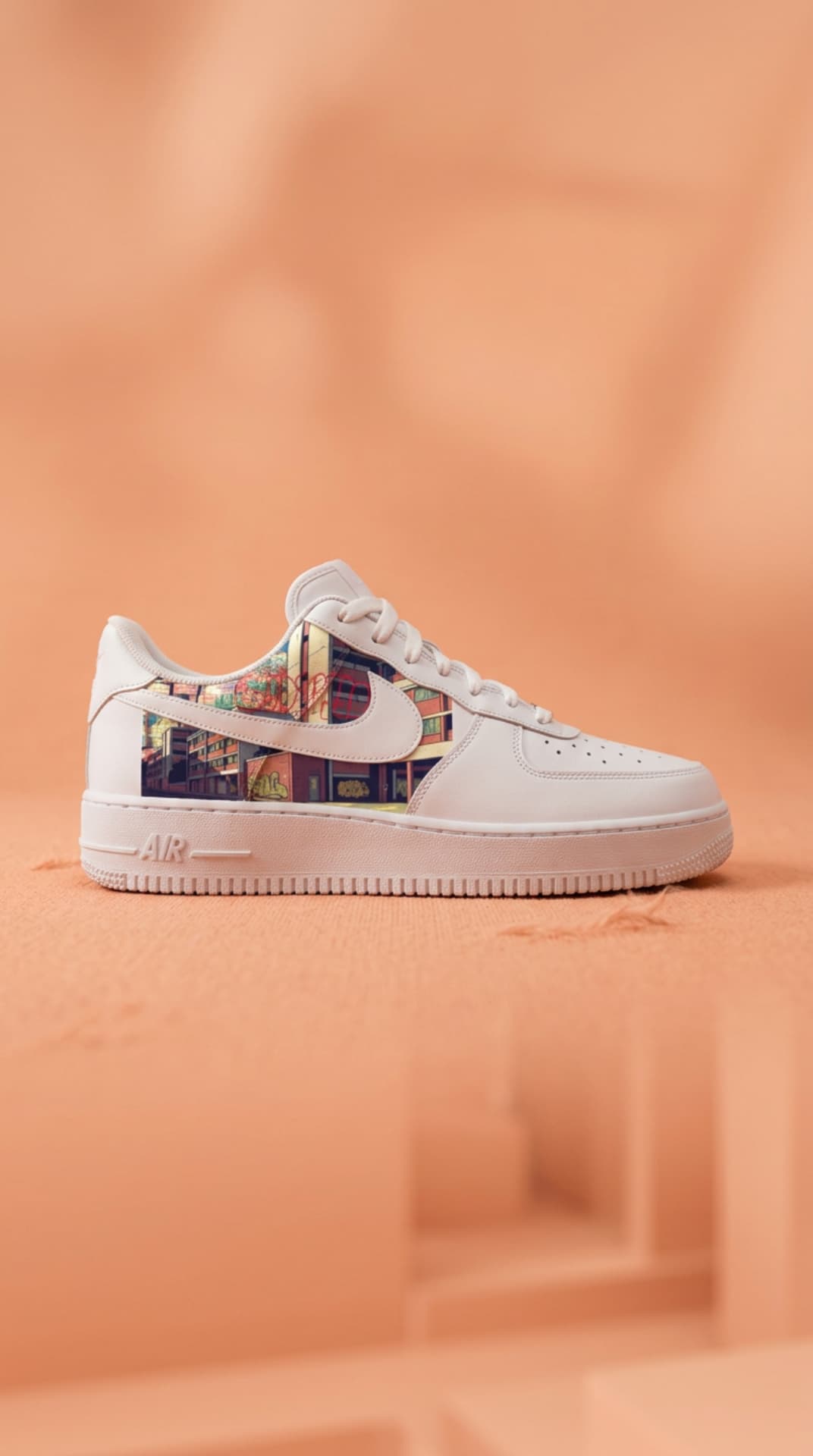 White Air Force 1 with a graffiti city-street print panel on a soft peach set