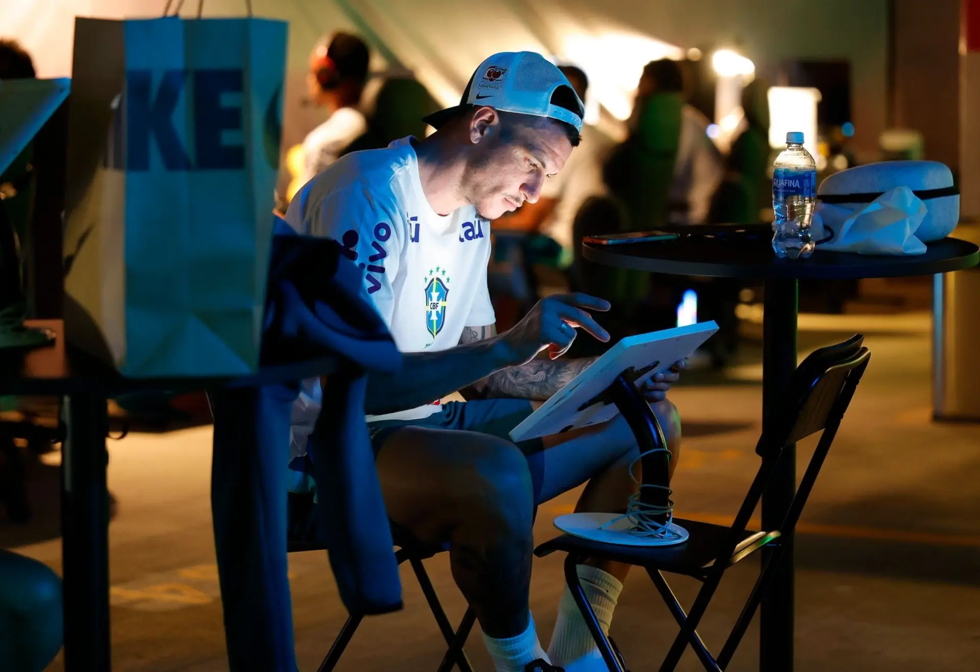 Brazil athlete seated with a tablet, working on his design