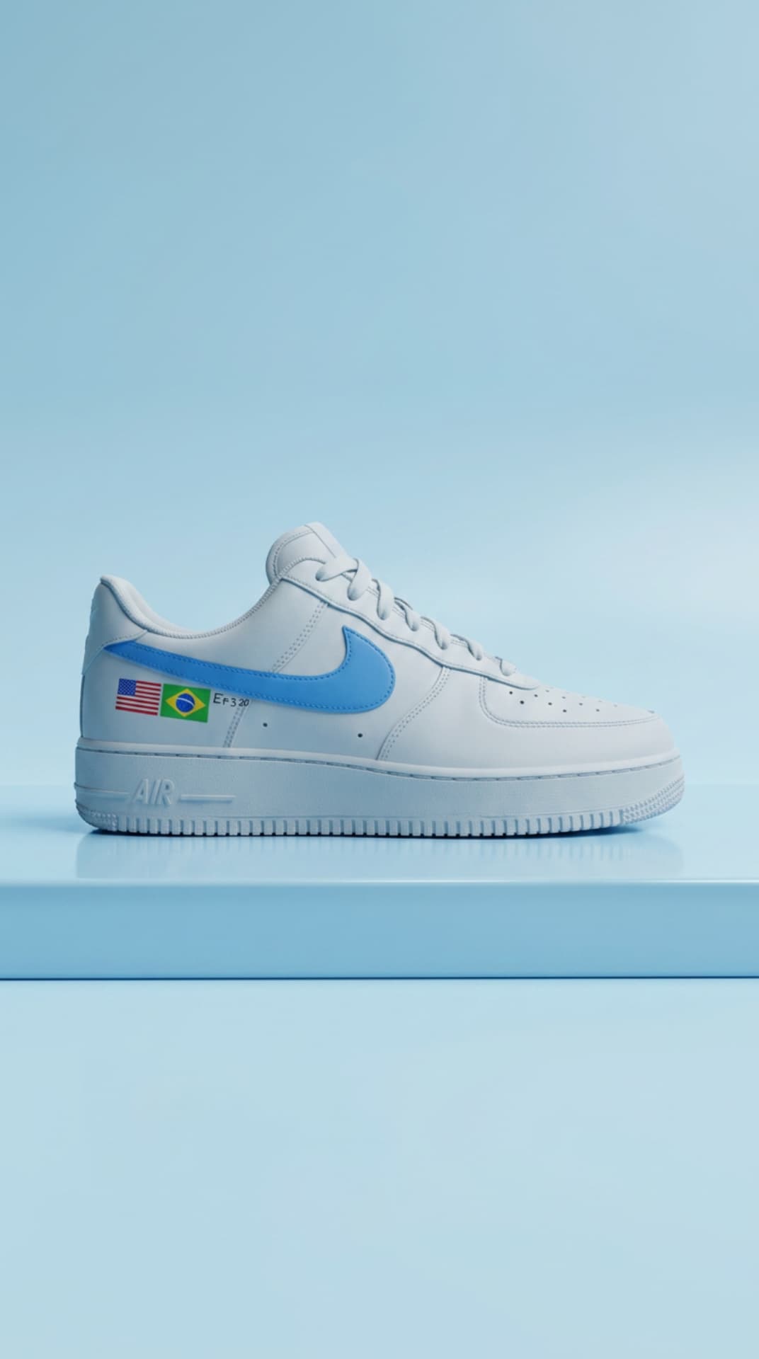 White Air Force 1 with a sky blue swoosh and USA and Brazil flag decals, on a pale blue plinth