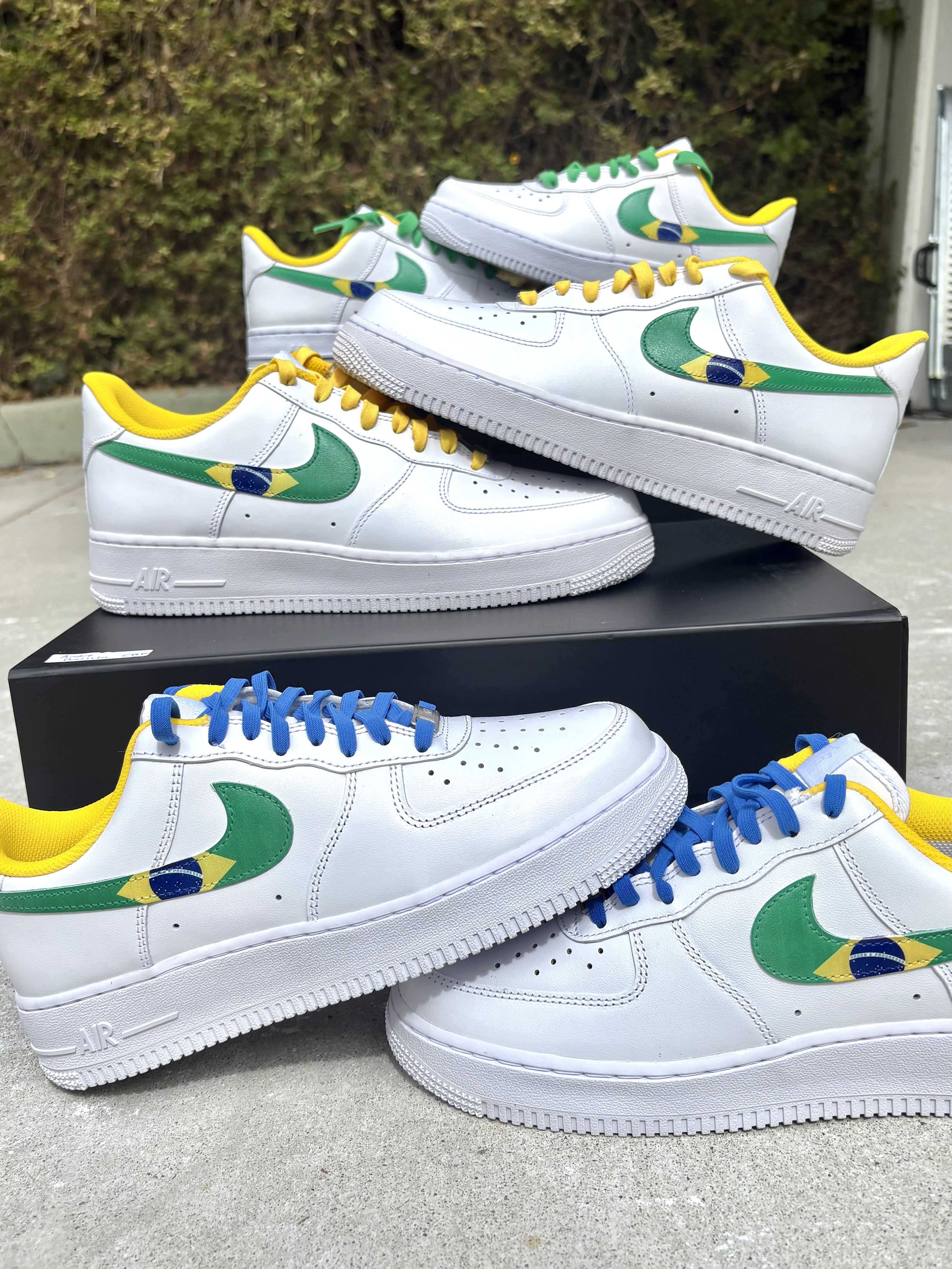 Four pairs of custom Air Force 1s with Brazil flag swooshes and yellow, green and blue laces
