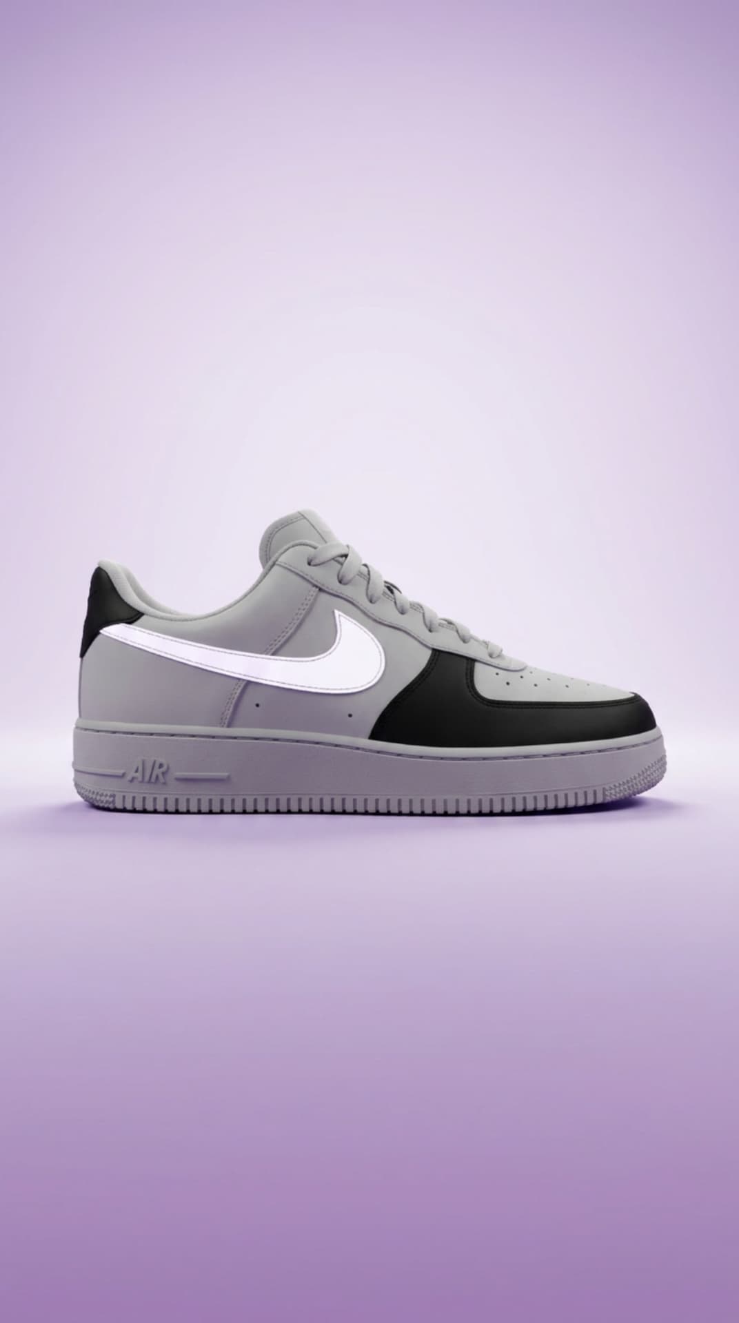 Grey and black Air Force 1 with a white swoosh against a soft lavender studio backdrop