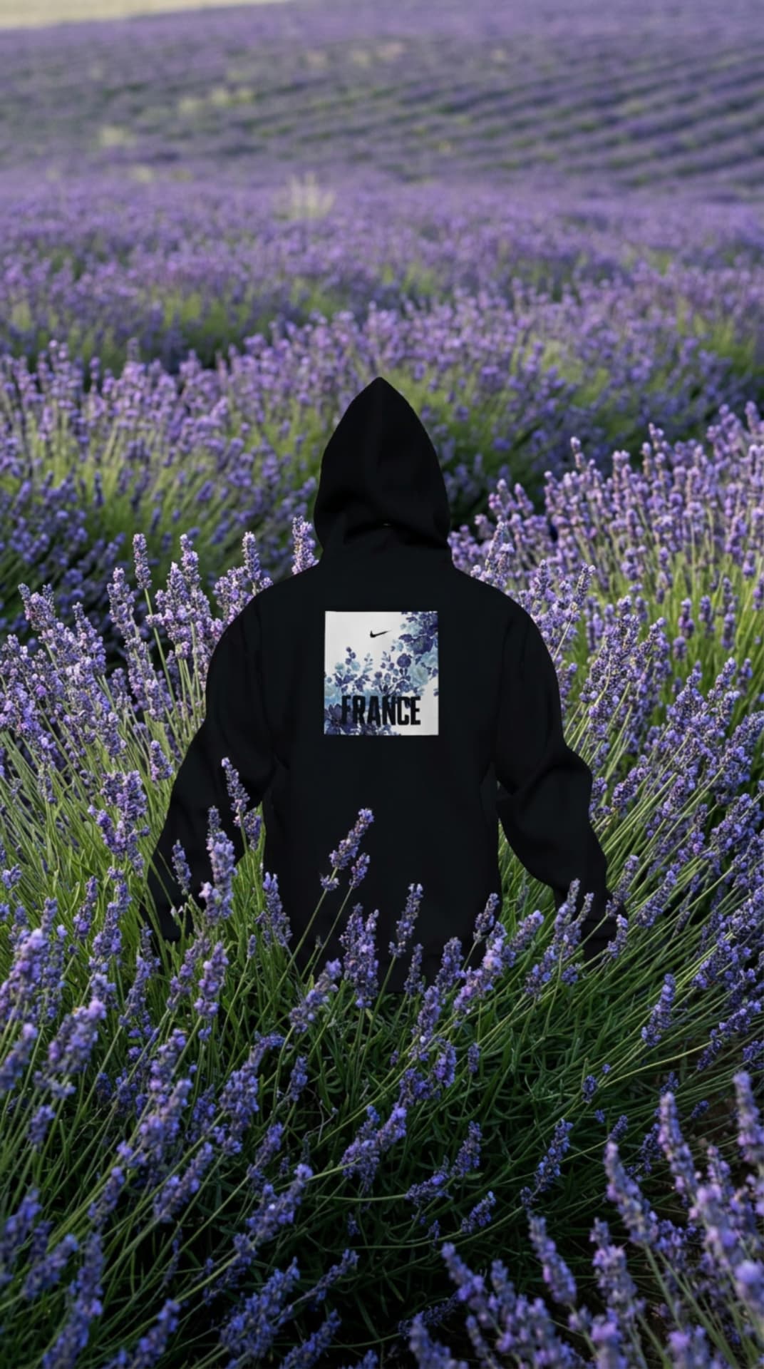 Black FRANCE floral-graphic hoodie worn in a lavender field