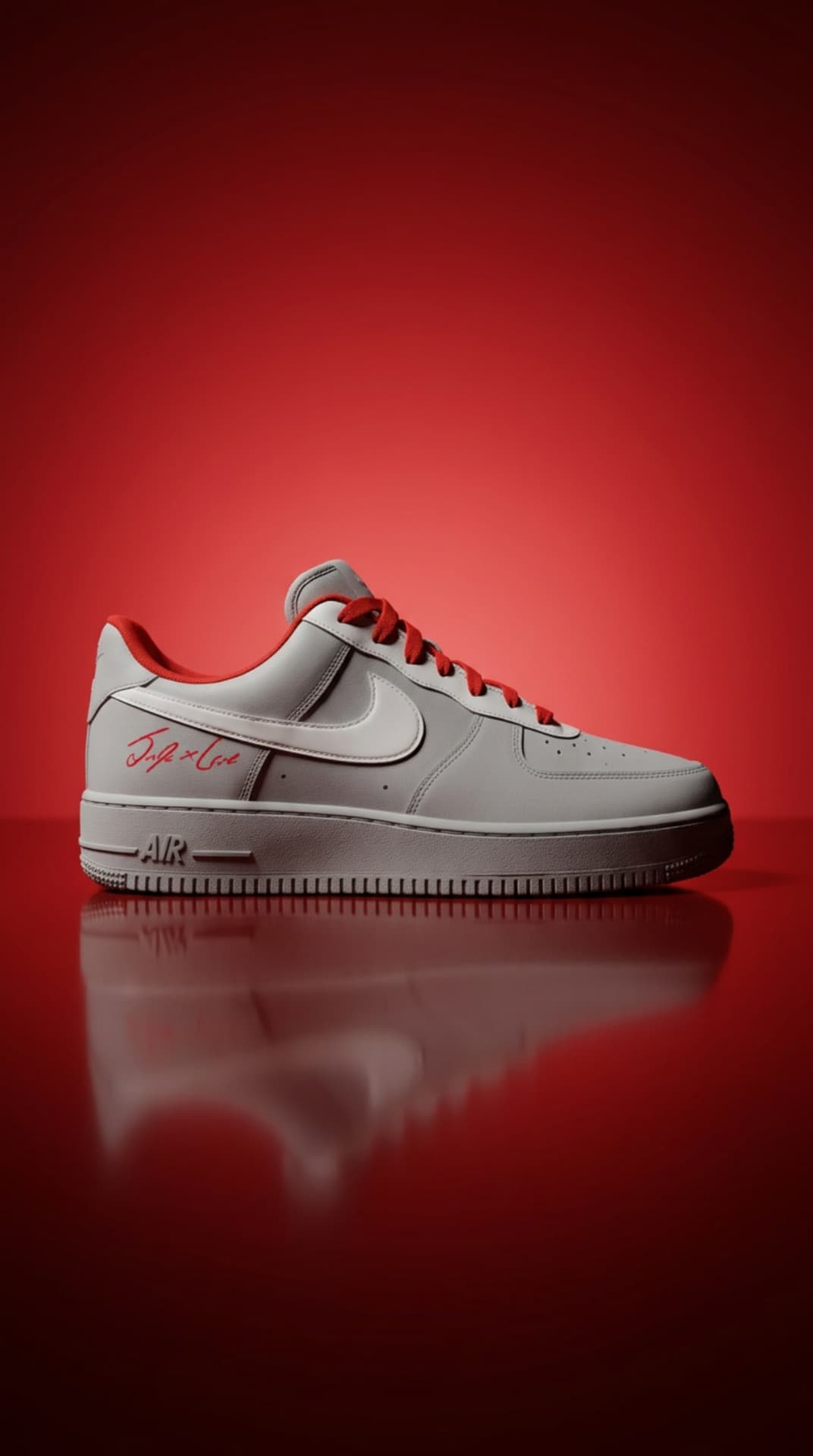 White Air Force 1 with red laces, red heel lining and a red script signature on a crimson gradient backdrop