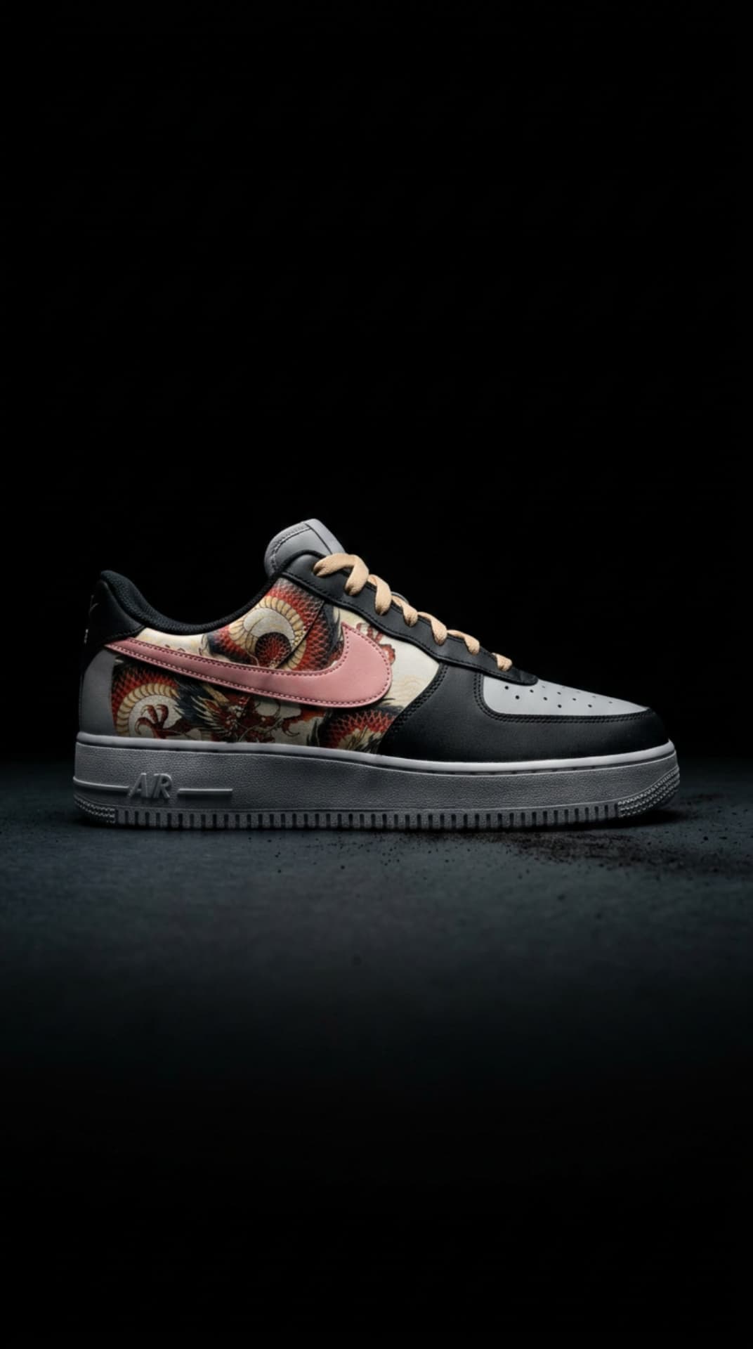 Black and grey Air Force 1 with a red dragon print panel, pink swoosh and peach laces on a dark studio floor